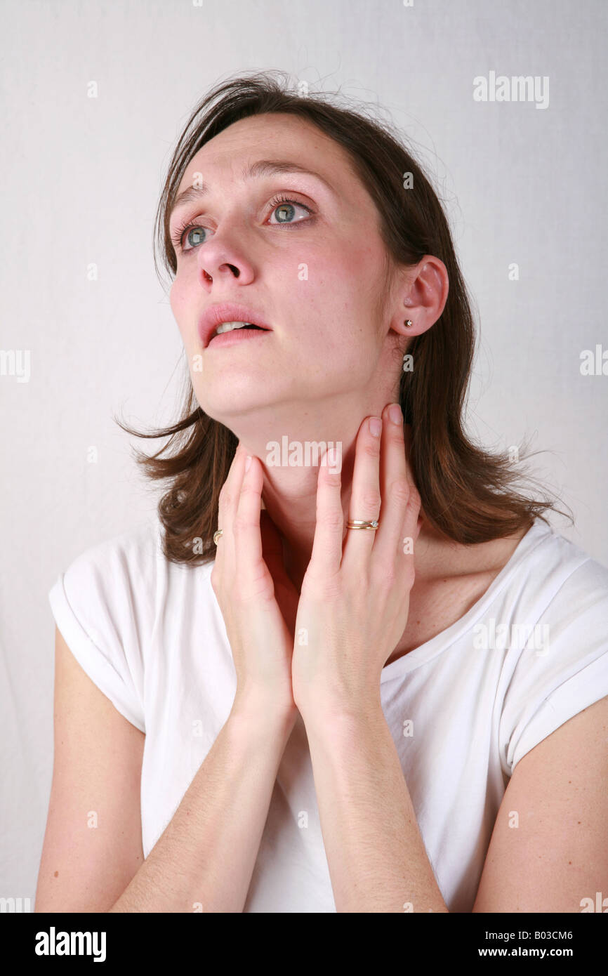 Young woman holding neck throat suffering from sore throat and swollen