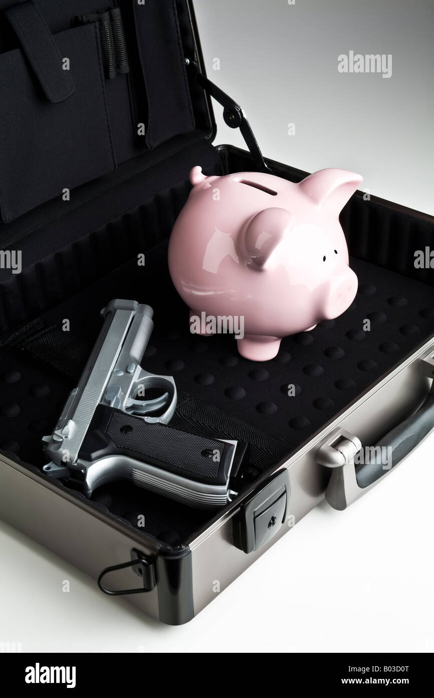 Piggy bank and a gun in a briefcase Stock Photo