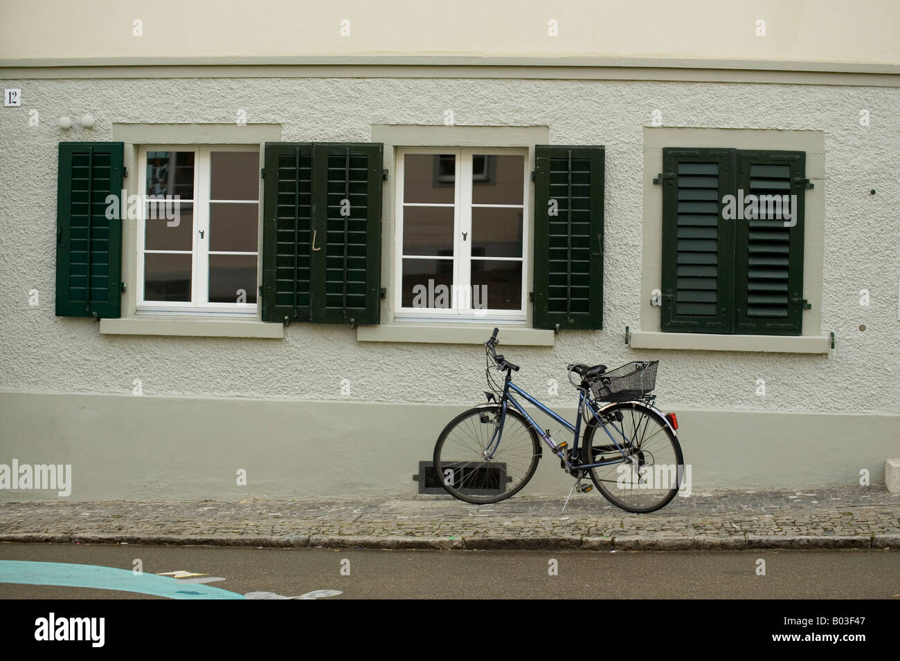 bicycle leaning against a wall in Wil, Switzerland Stock Photo