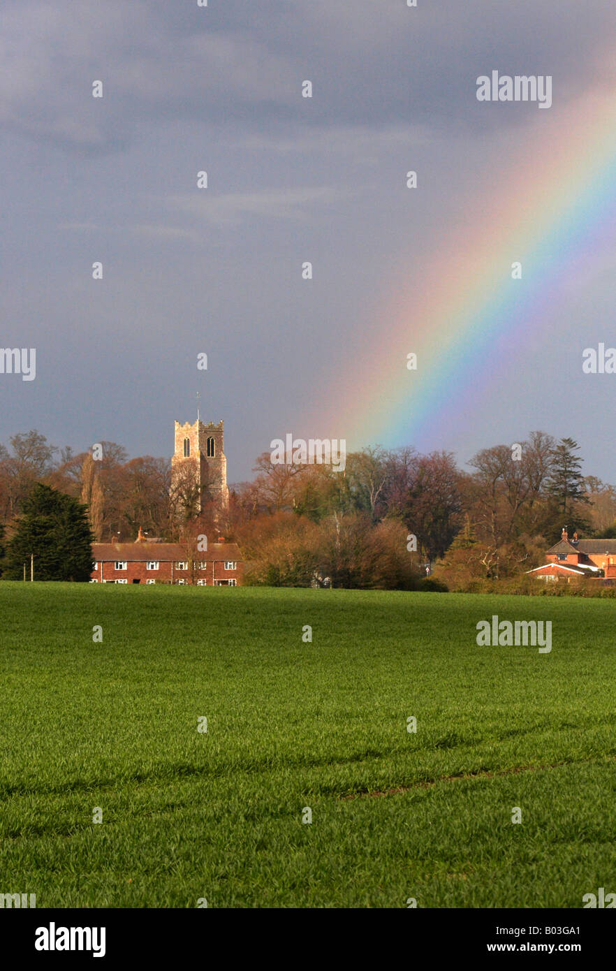 Traditional English church with a rainbow behind in the Norfolk Countryside close to the Halvergate Marshes, Norfolk Broads Stock Photo
