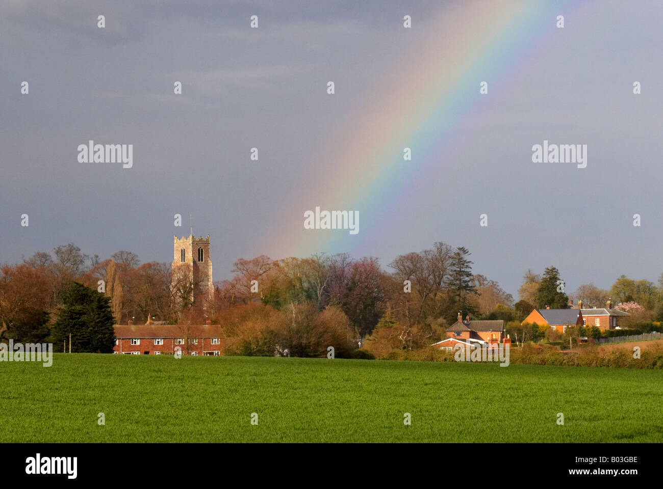 Traditional English church with a rainbow behind in the Norfolk Countryside close to the Halvergate Marshes, Norfolk Broads Stock Photo