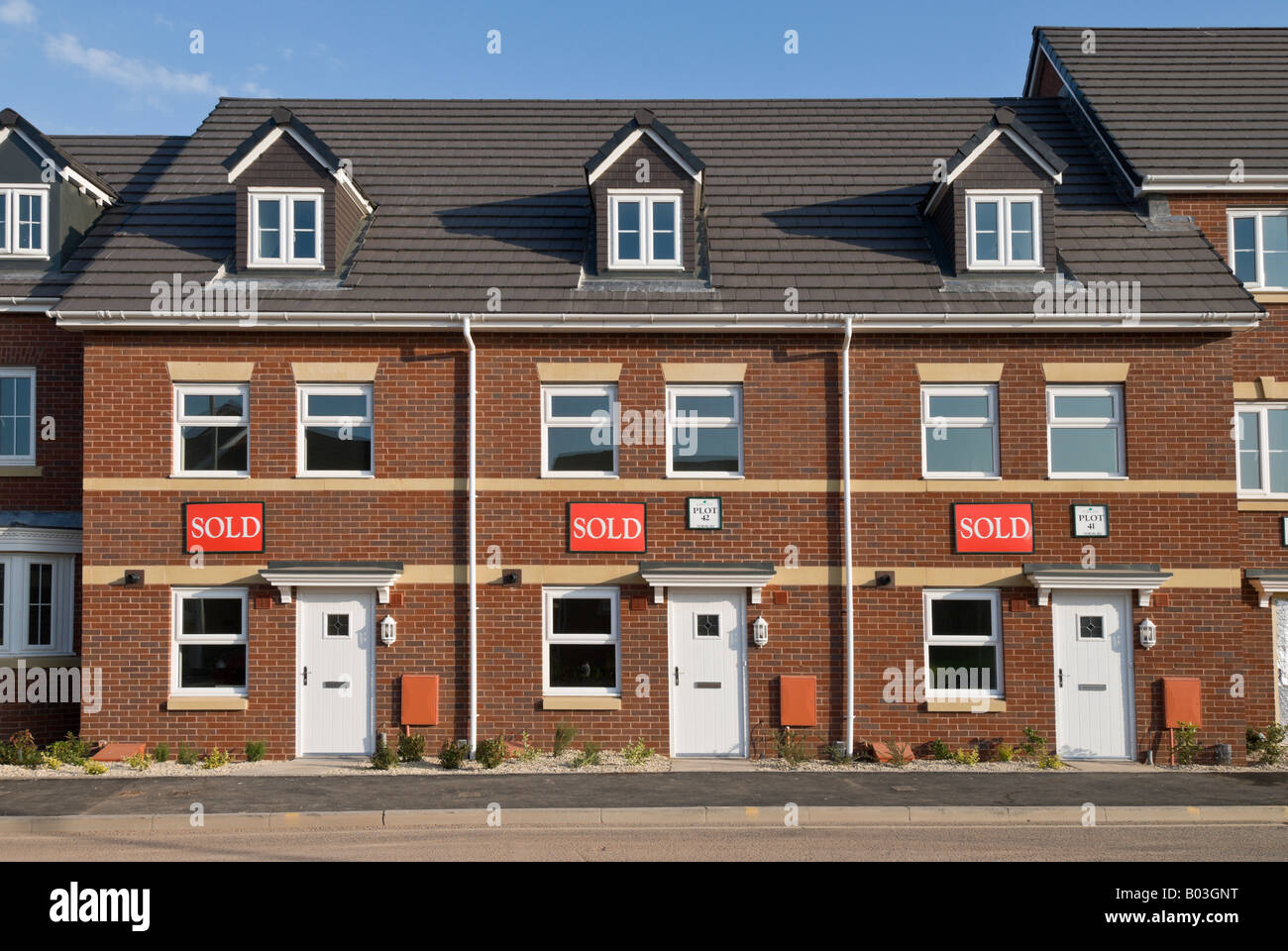 A row of new houses in the UK each with SOLD written on them. Stock Photo