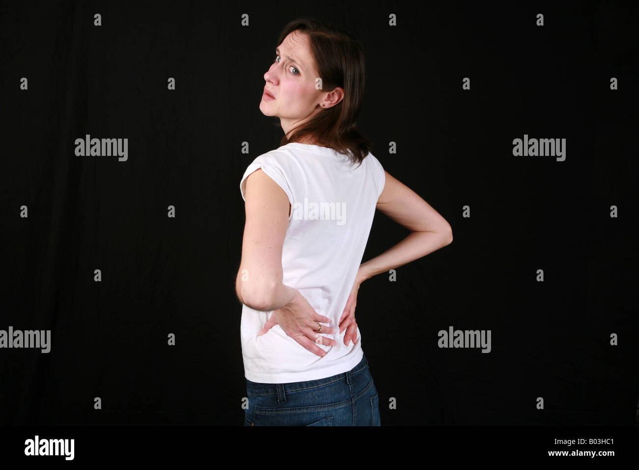 Young woman suffering from chronic back ache painful back spine slipped