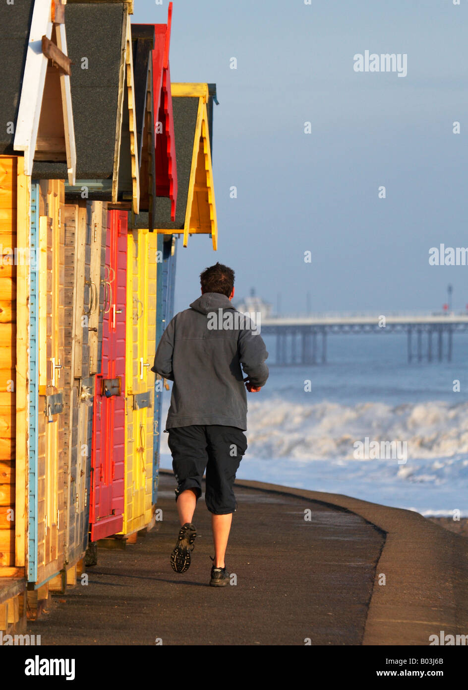 One man walking past beach huts hi-res stock photography and images - Alamy
