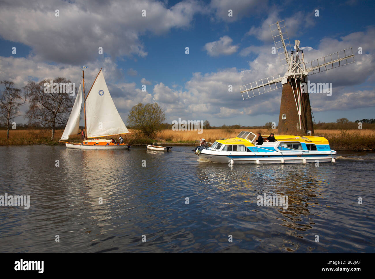 Turf Fen windmill with a traditional sailing boat and a modern motor cruiser on the River Ant, Norfolk Broads Stock Photo