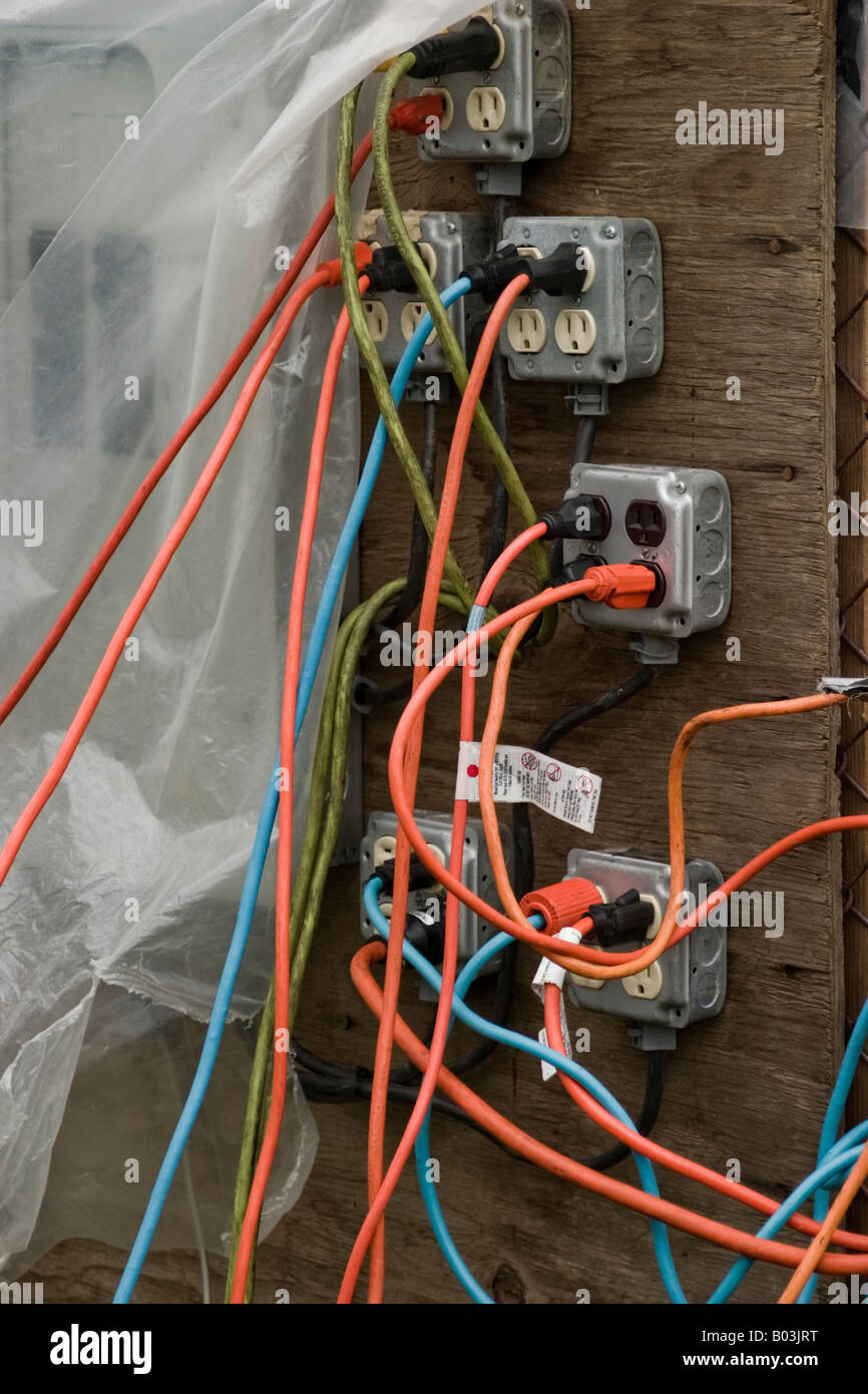 Colored wire plugged into several electrical outlets Stock Photo Alamy
