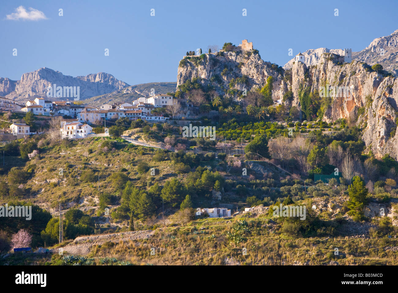 Ruins of Castell de Guadalest, Castle of Guadalest, and the white washed church belfry in the town of Guadalest Stock Photo