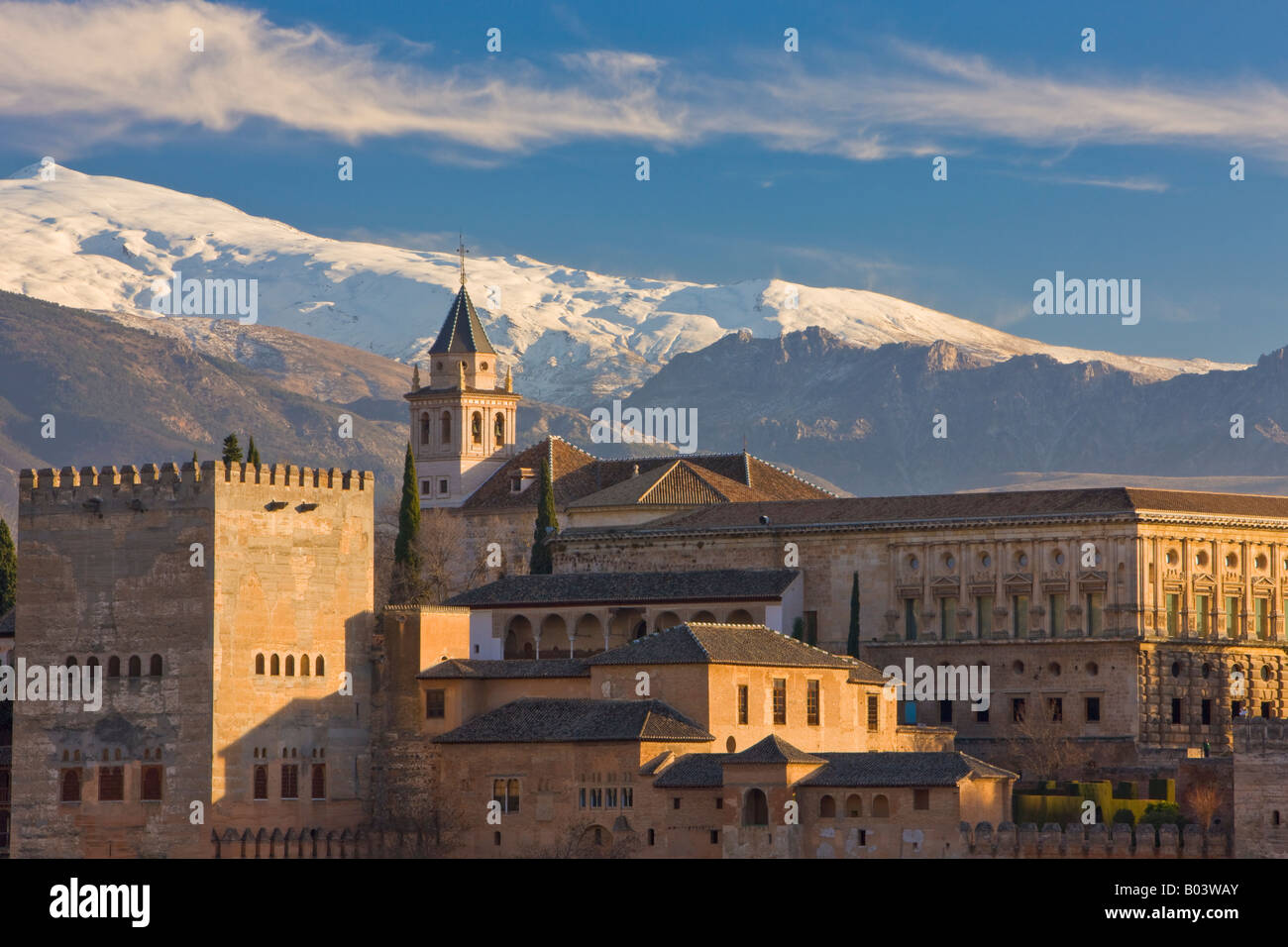 The Alhambra (La Alhambra) - a UNESCO World Heritage Site, backdropped by the Sierra Nevada Mountain Range at sunset Stock Photo