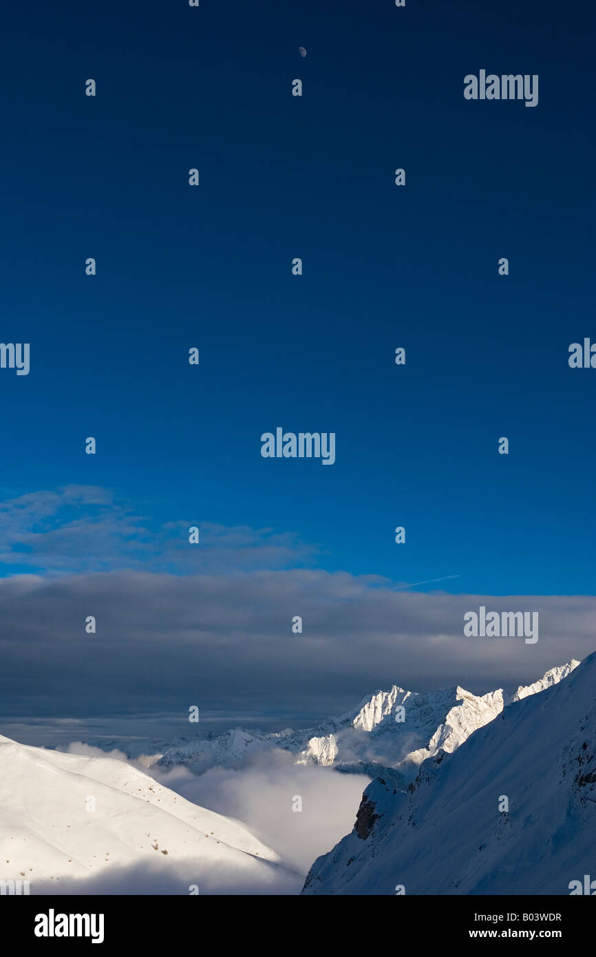 Mountains above Passo del Tonale Italy with the moon visable Stock Photo