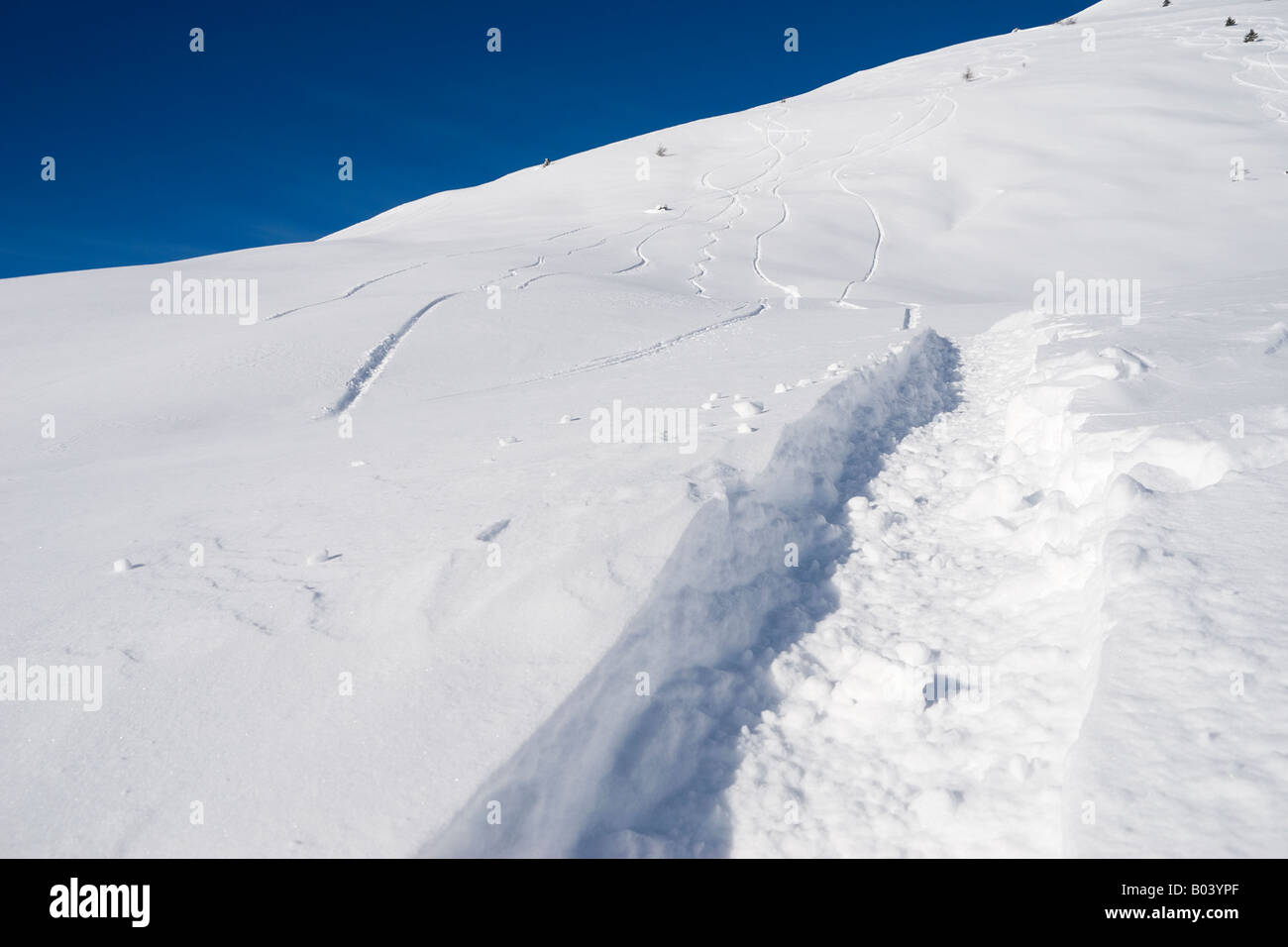 Deep snow and snowboarder tracks above Passo del Tonale Stock Photo