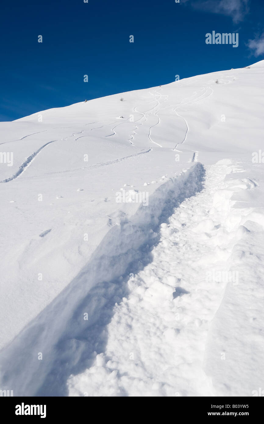 Deep snow and snowboarder tracks above Passo del Tonale Stock Photo