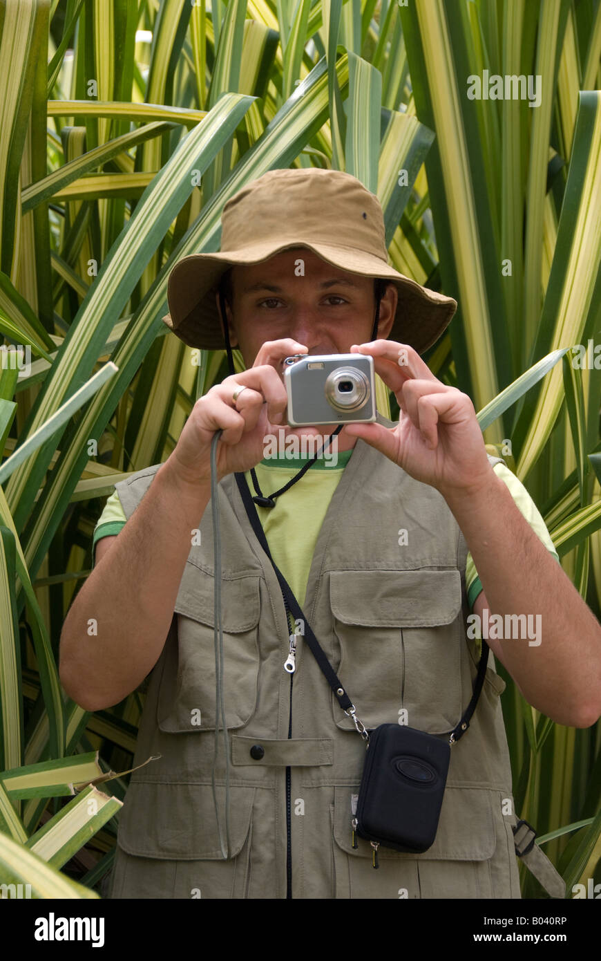 a young man taking photographs in a forest Stock Photo