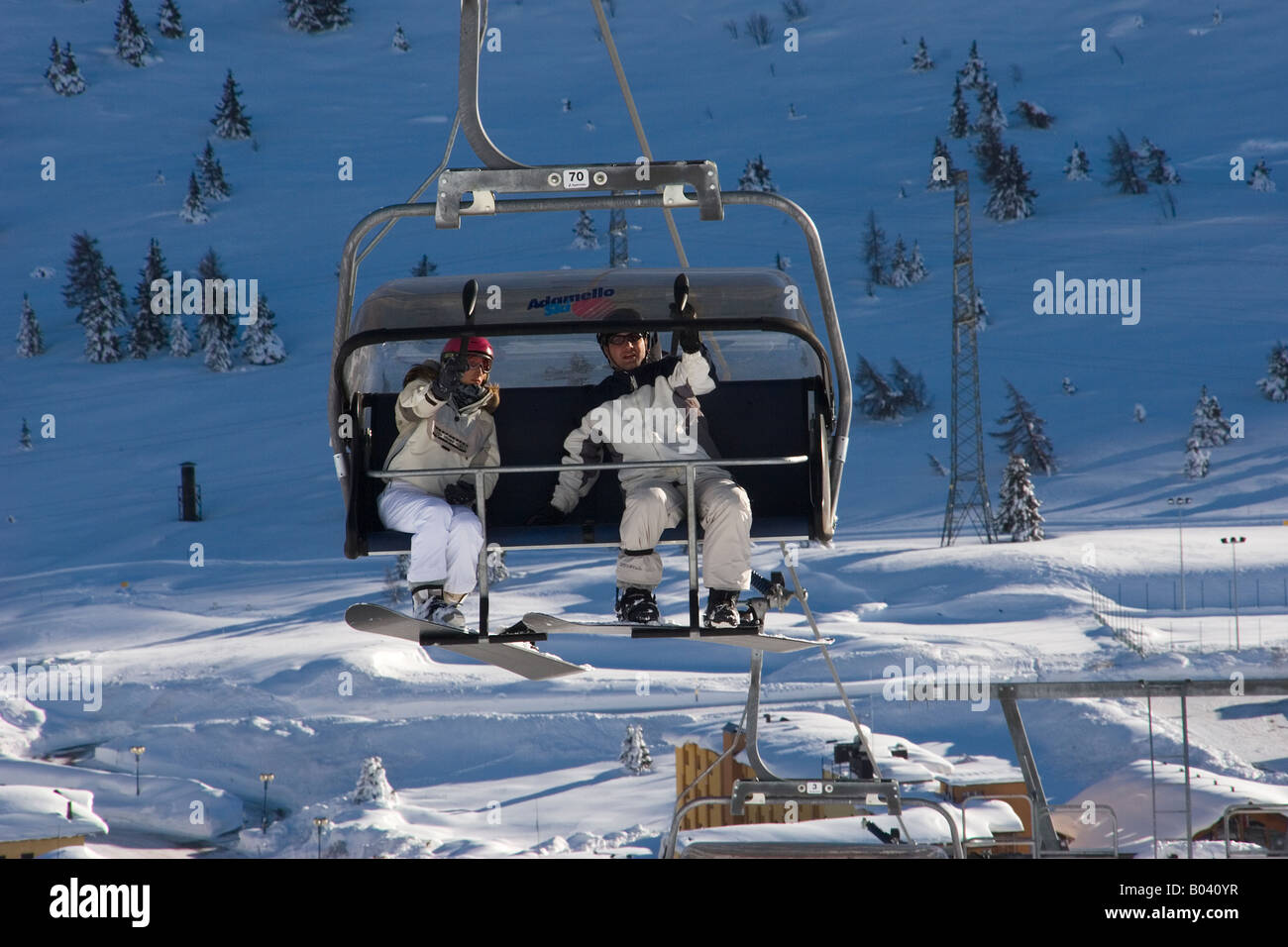 Snowboarders on a ski lift Stock Photo