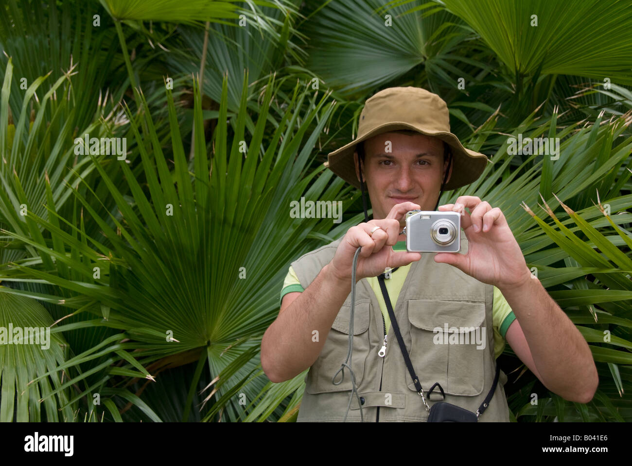 a young man taking photographs in a forest Stock Photo
