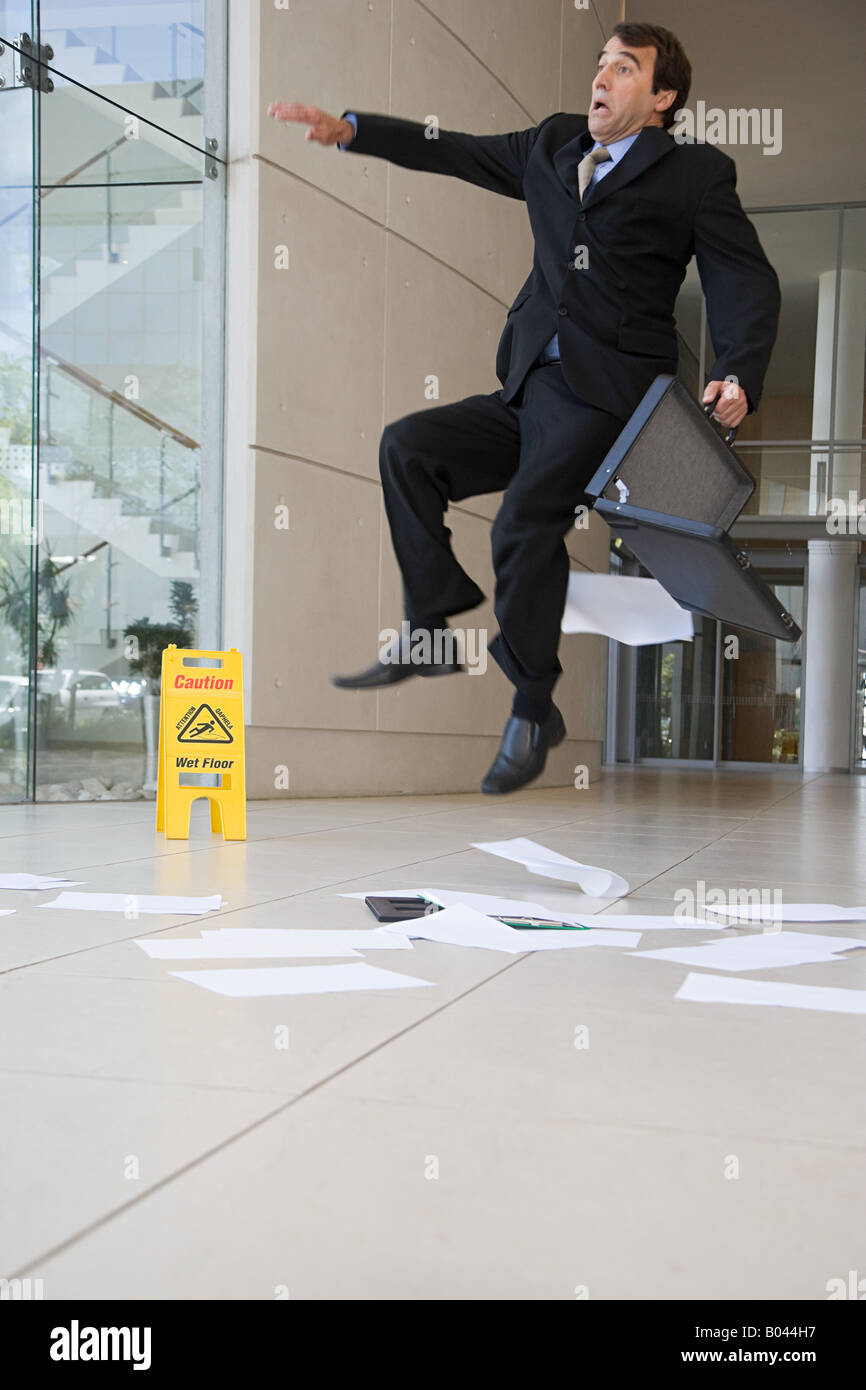 Businessman slipping up Stock Photo - Alamy