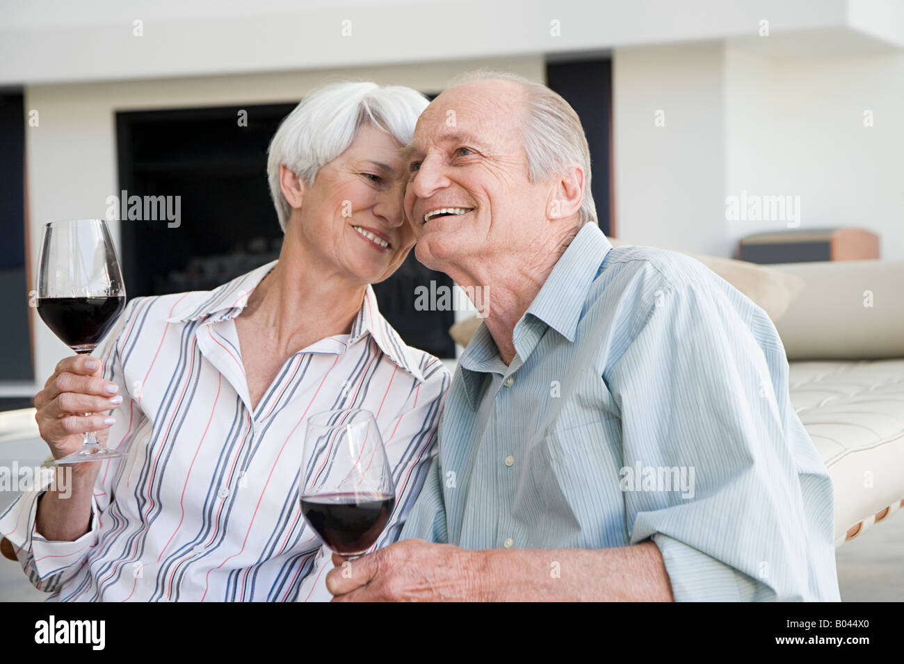 A senior couple having a glass of red wine Stock Photo - Alamy