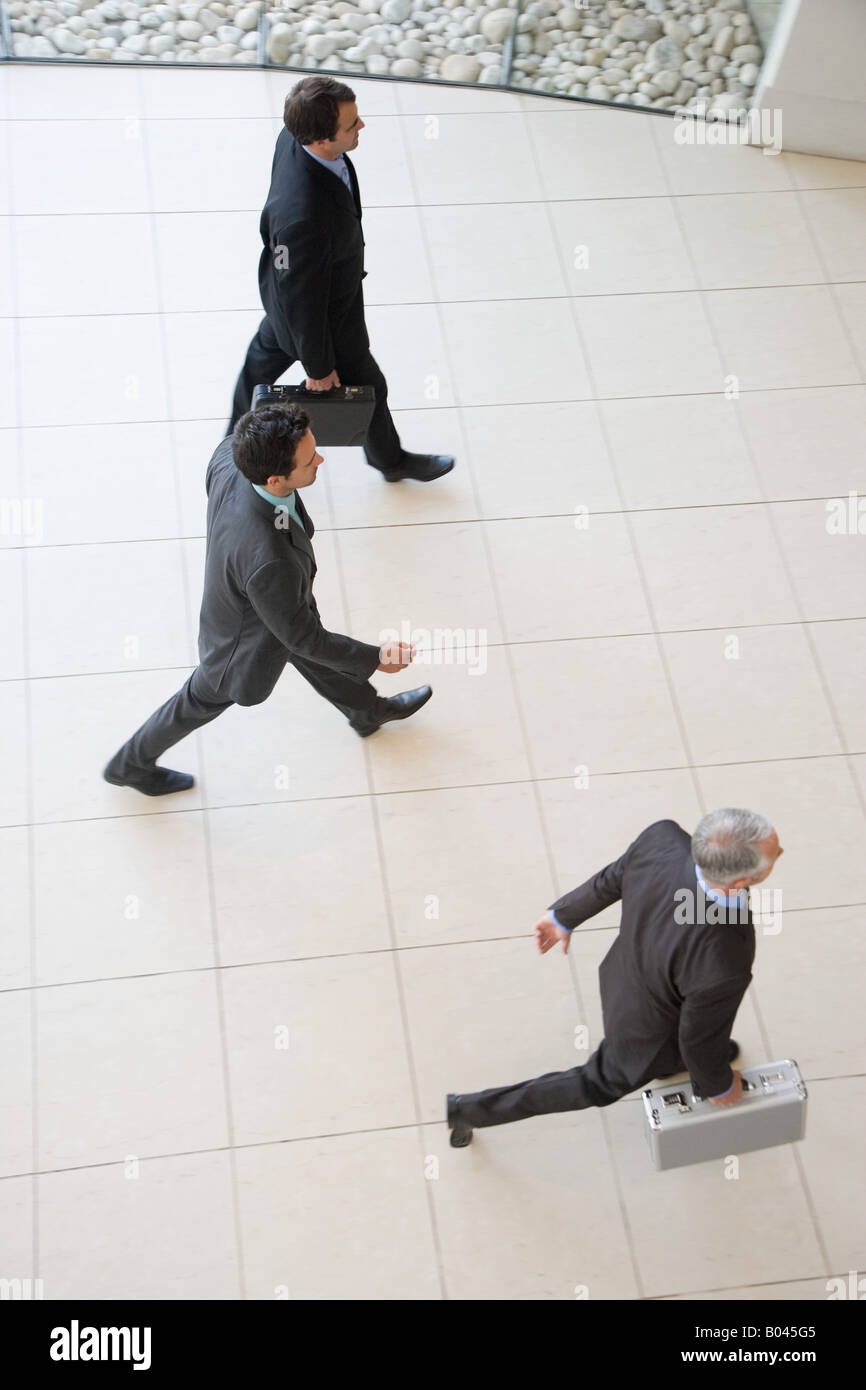 Three businessmen walking Stock Photo - Alamy