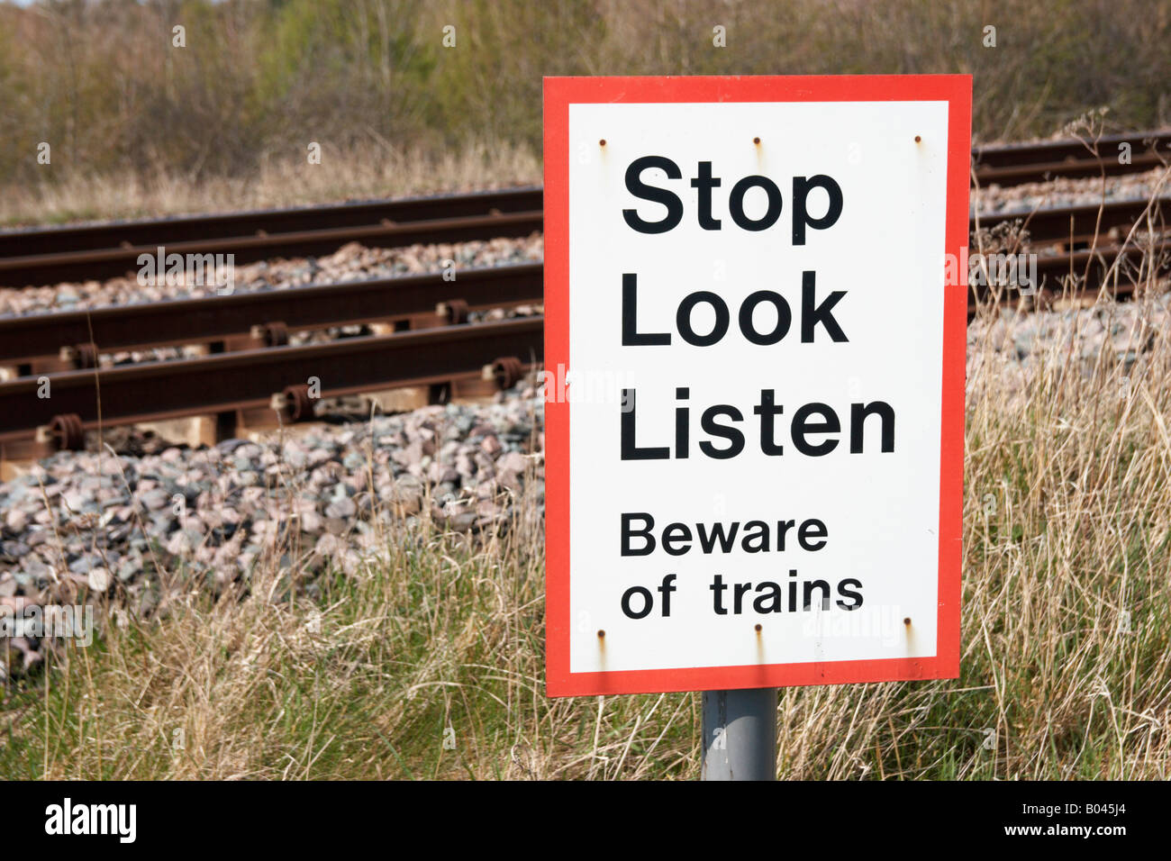Beware of trains sign near railway track in England Stock Photo - Alamy
