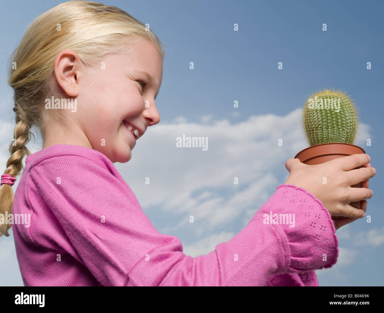 Girl holding a cactus Stock Photo