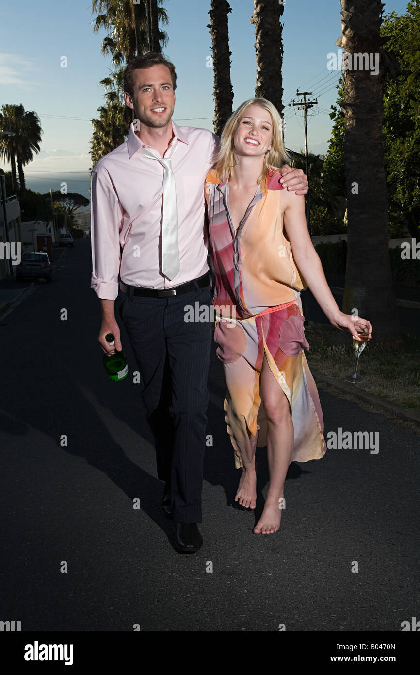 Couple walking from party Stock Photo