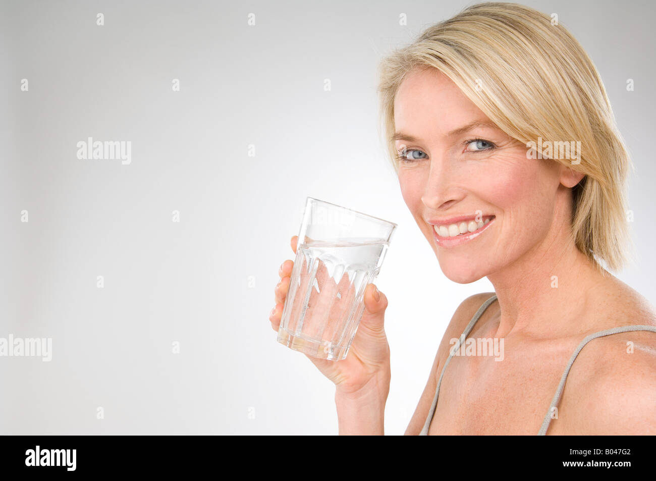A woman holding a glass of water Stock Photo Alamy
