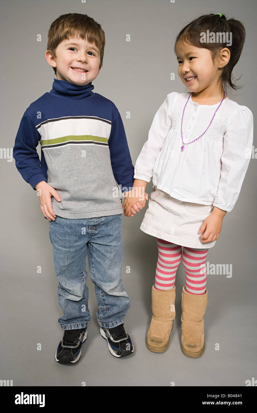 A boy and girl holding hands Stock Photo - Alamy