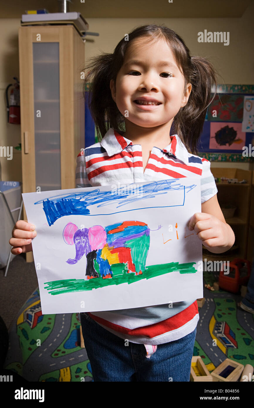 A girl showing a pencil drawing of an elephant Stock Photo