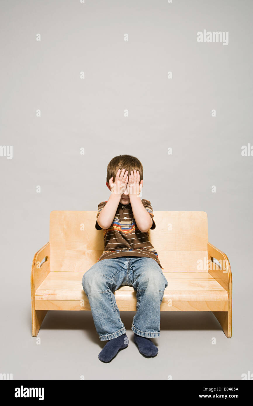 A boy covering his eyes Stock Photo - Alamy
