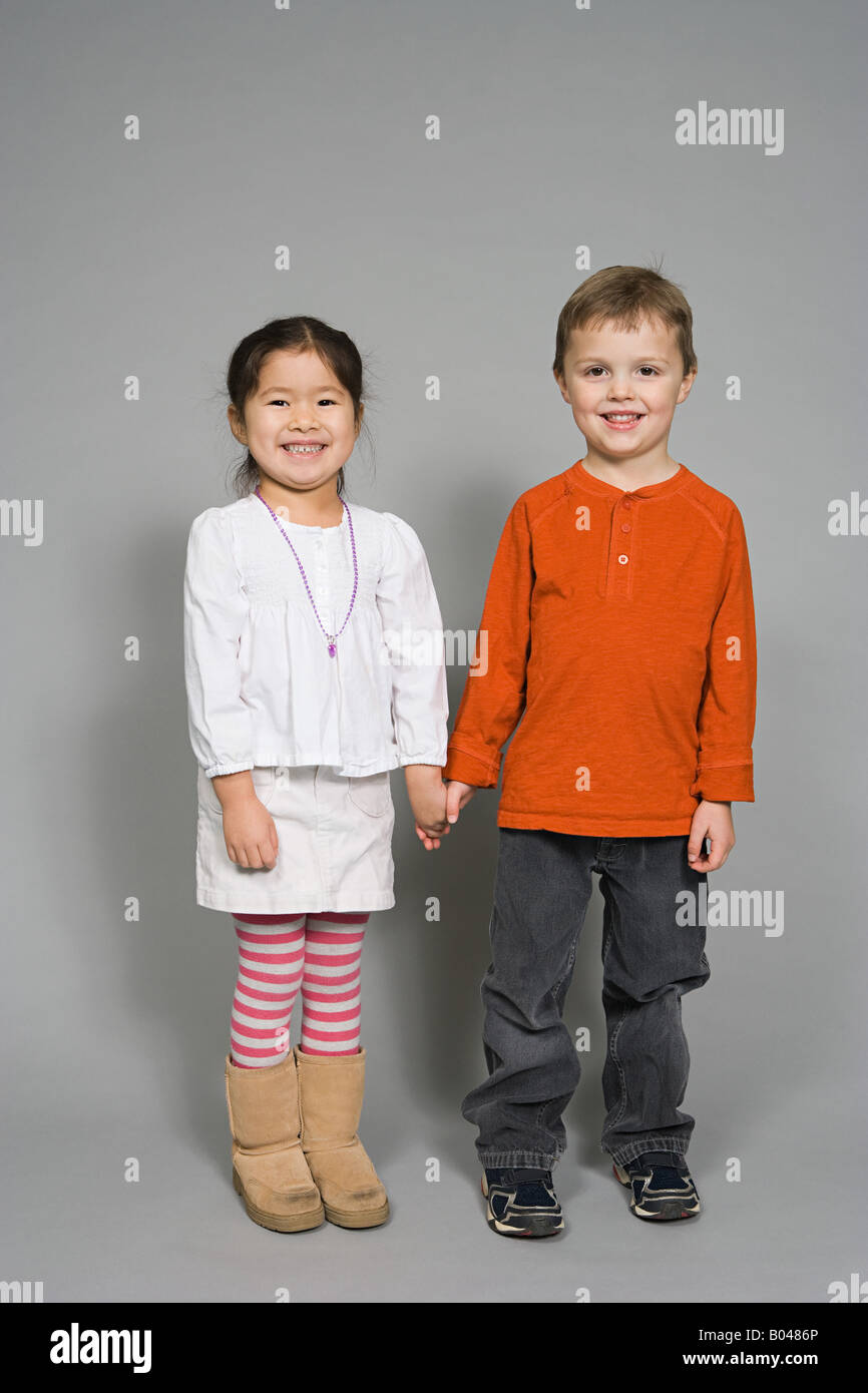 A boy and girl holding hands Stock Photo - Alamy