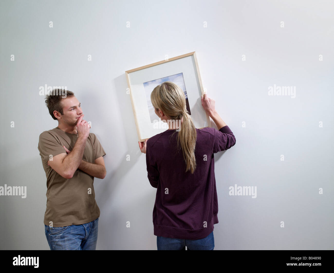 A couple putting art on a wall Stock Photo Alamy