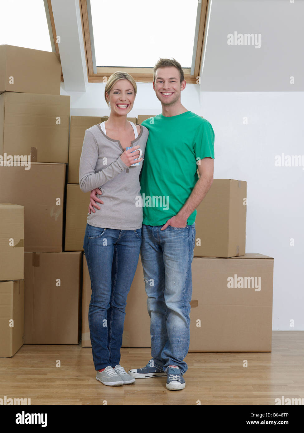 Portrait of a couple in their new home Stock Photo - Alamy