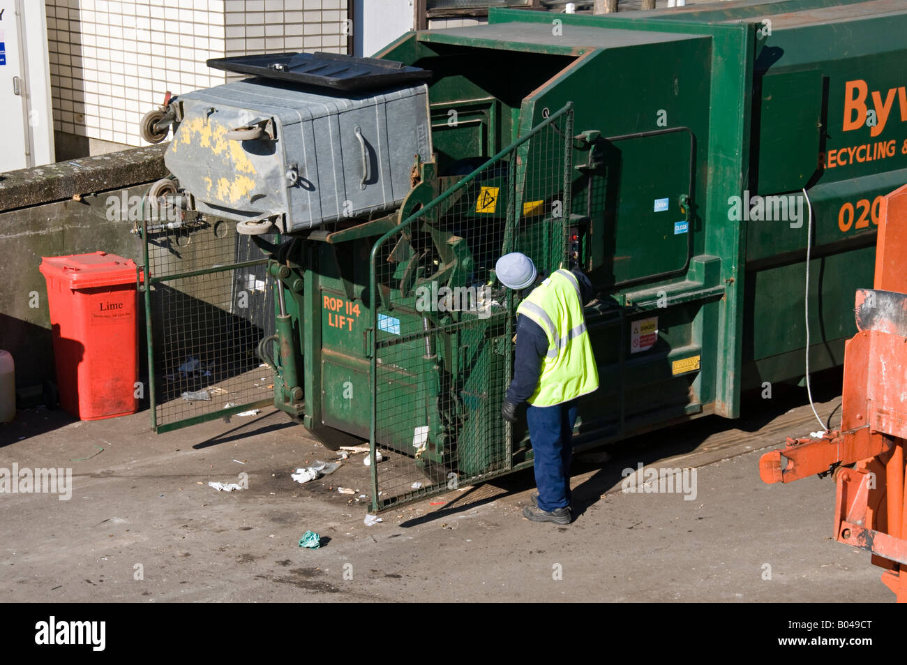 Man emptying rubbish bin into recycling container Stock Photo Alamy