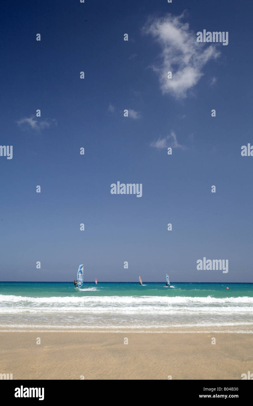 Abstract of beach, sea and blue sky with surfers, Beach La Barca, Playa Sotavento, Jandia, Fuerteventura, Canaries, Spain Stock Photo