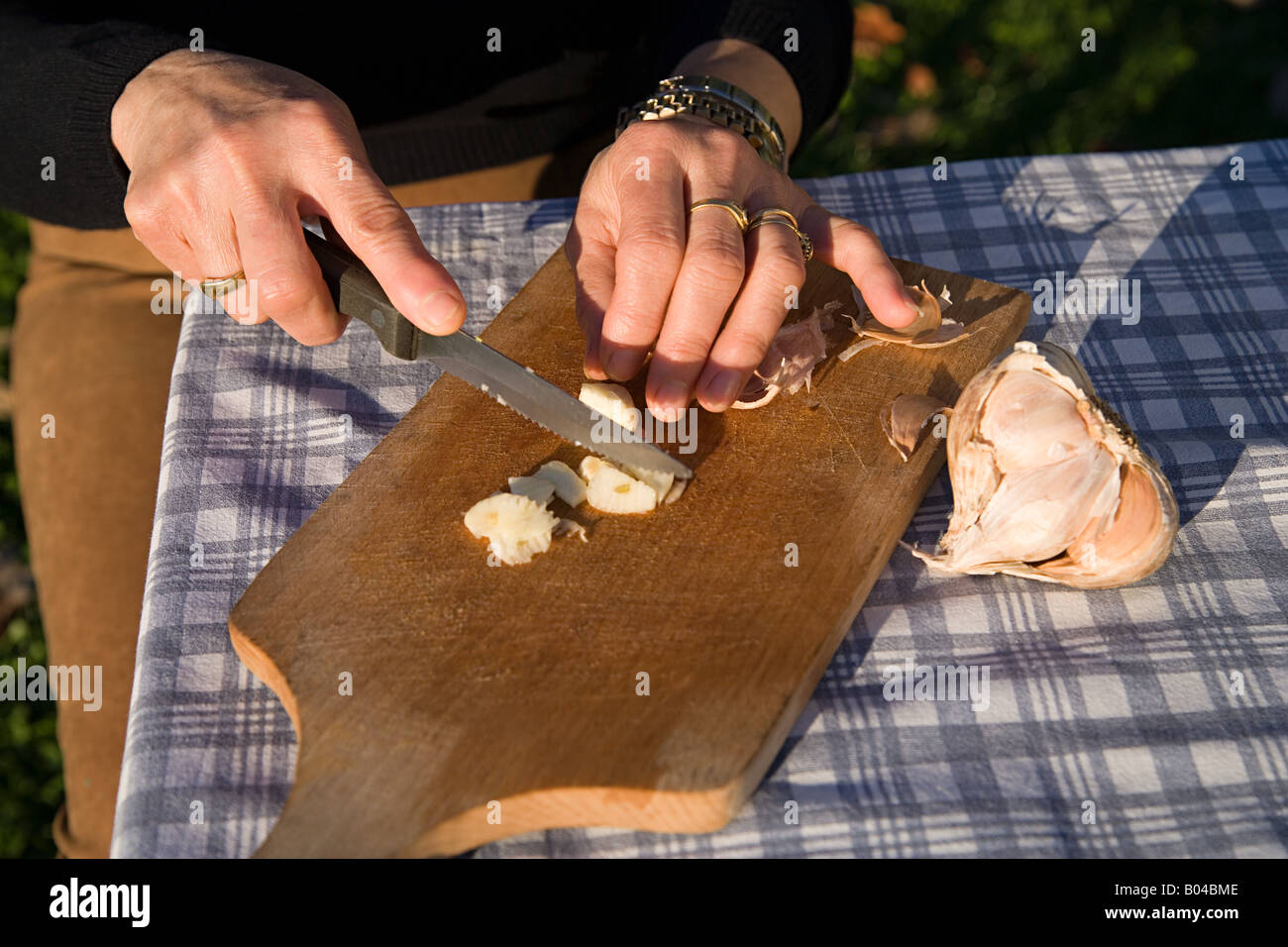 Woman chopping garlic Stock Photo Alamy