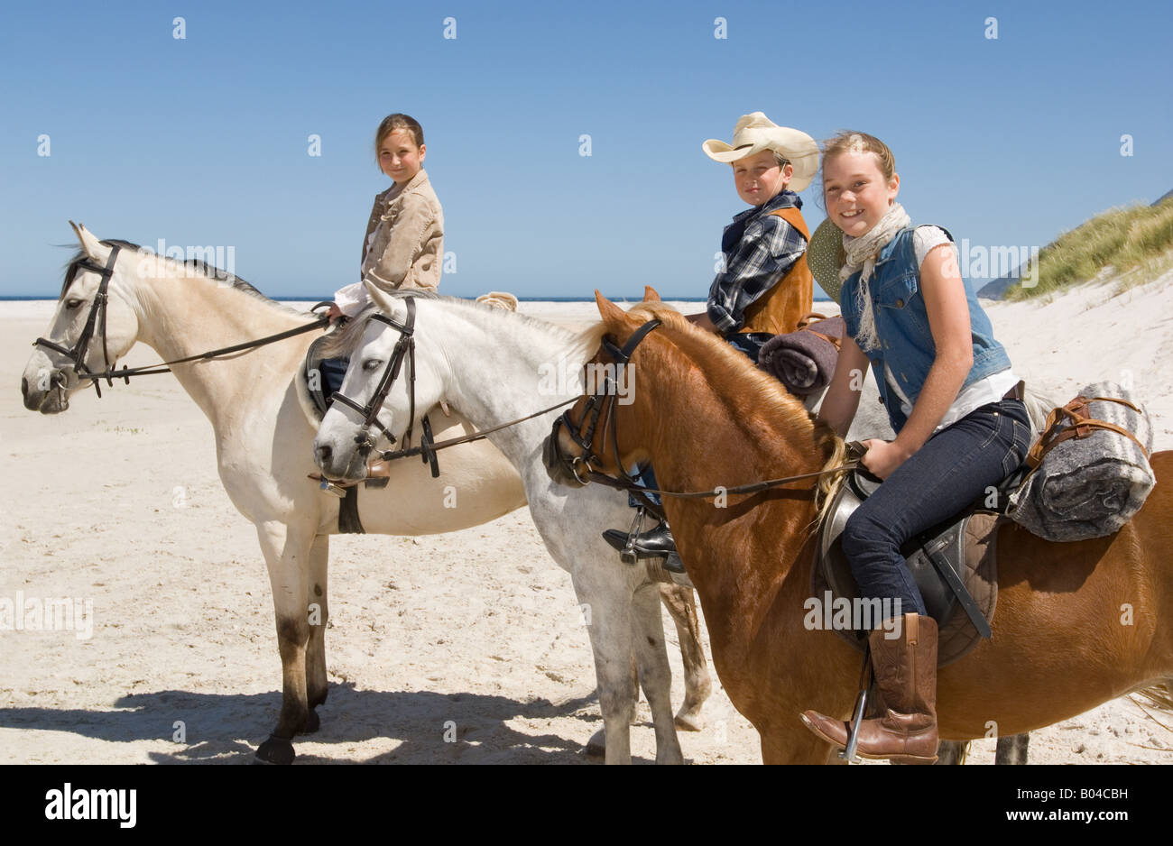 A boy and girls riding horses Stock Photo