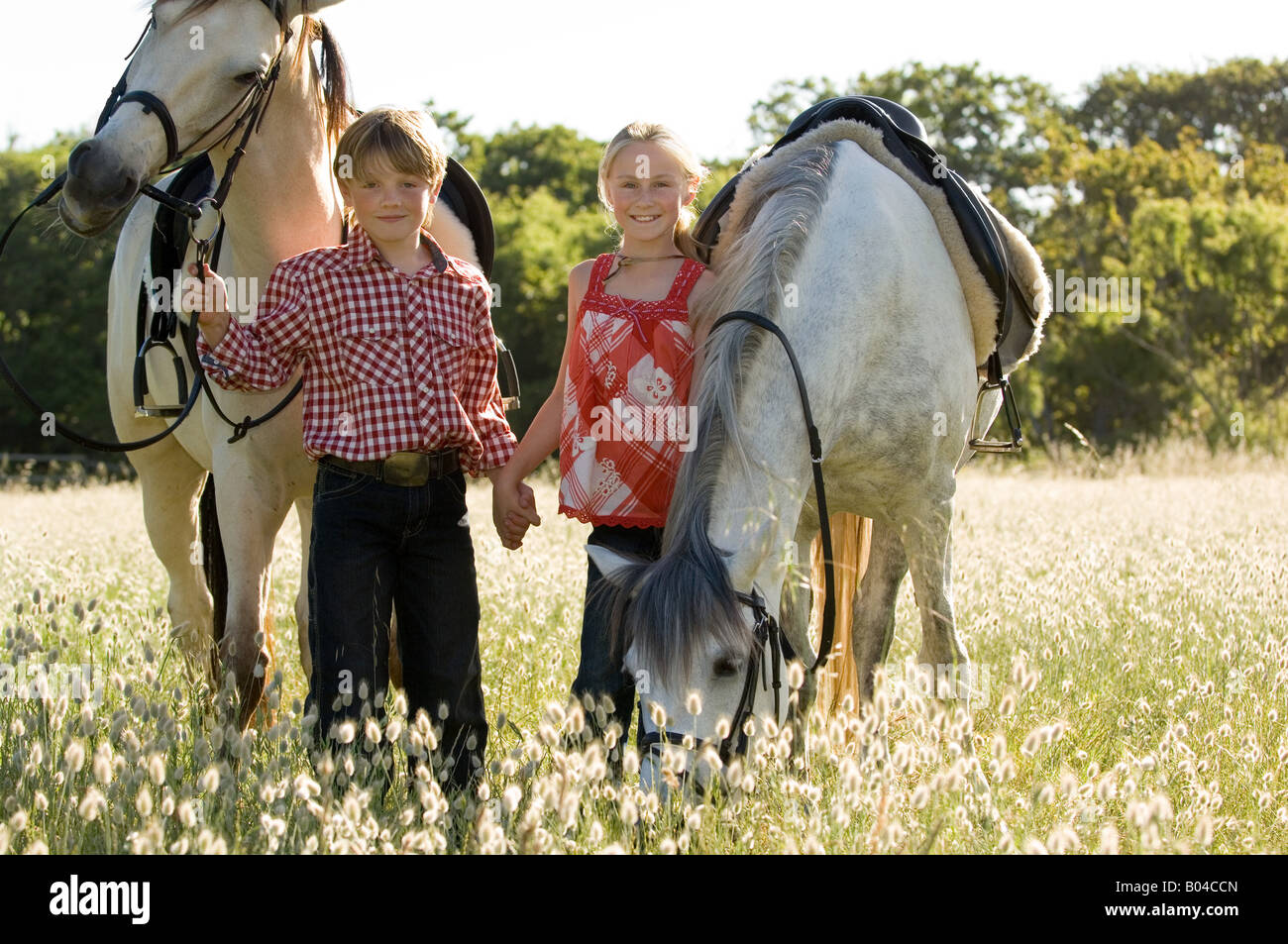A boy and girl with horses Stock Photo