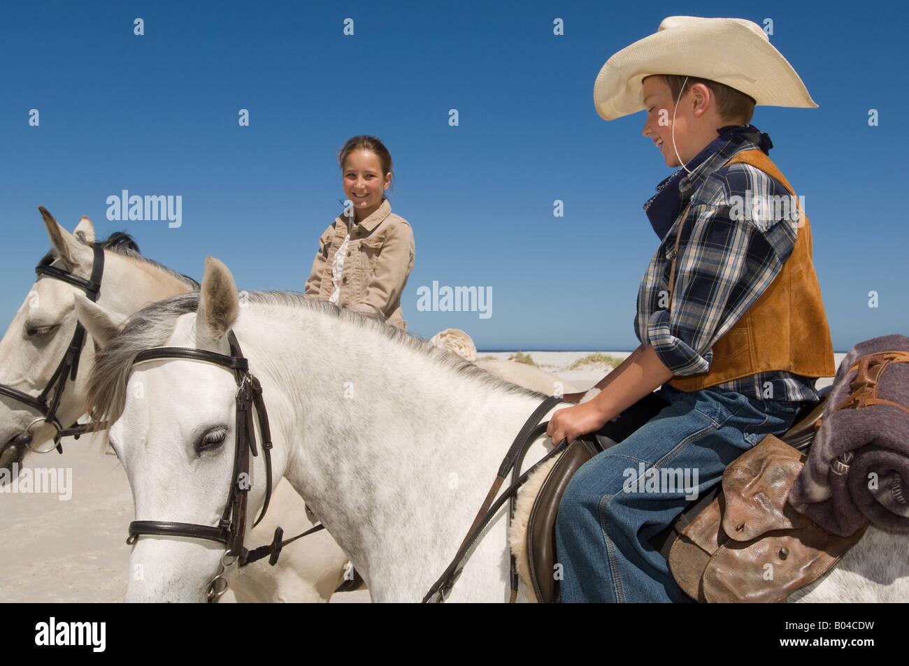 A boy and girl riding horses Stock Photo