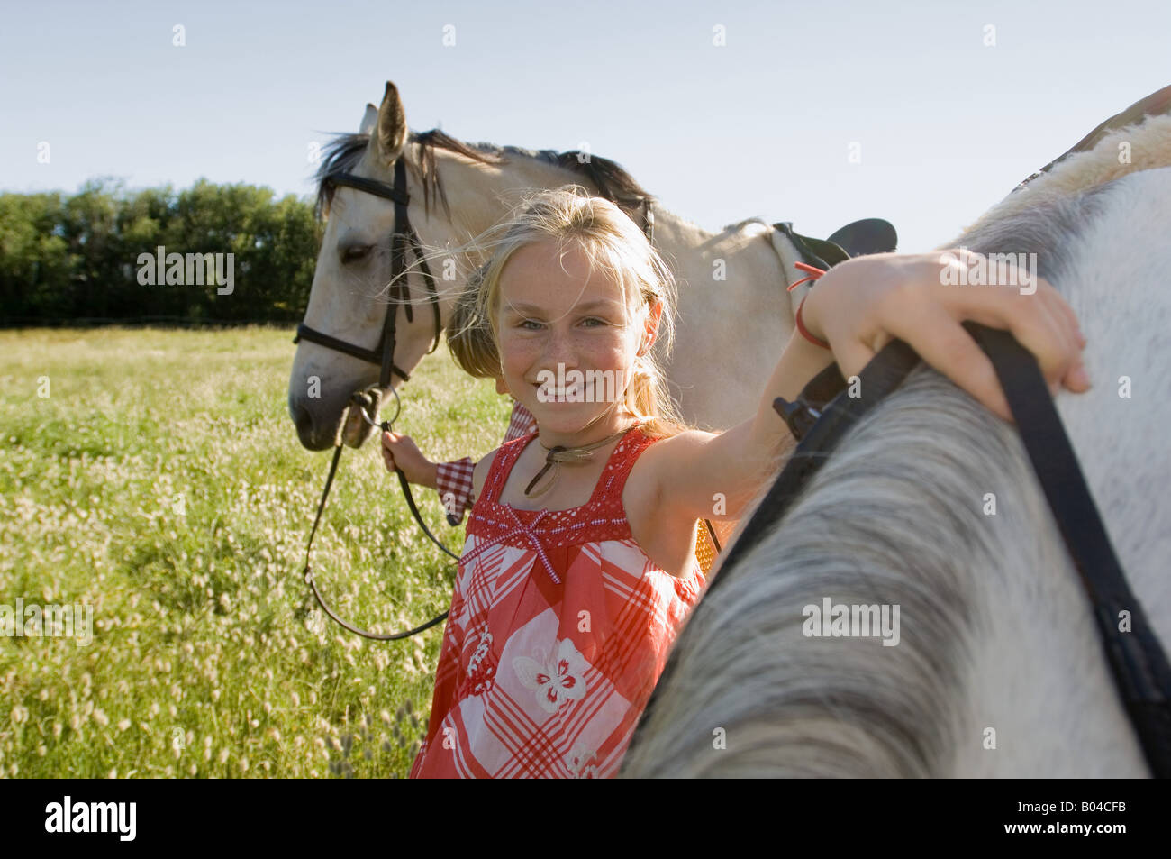 A boy and girl with horses Stock Photo