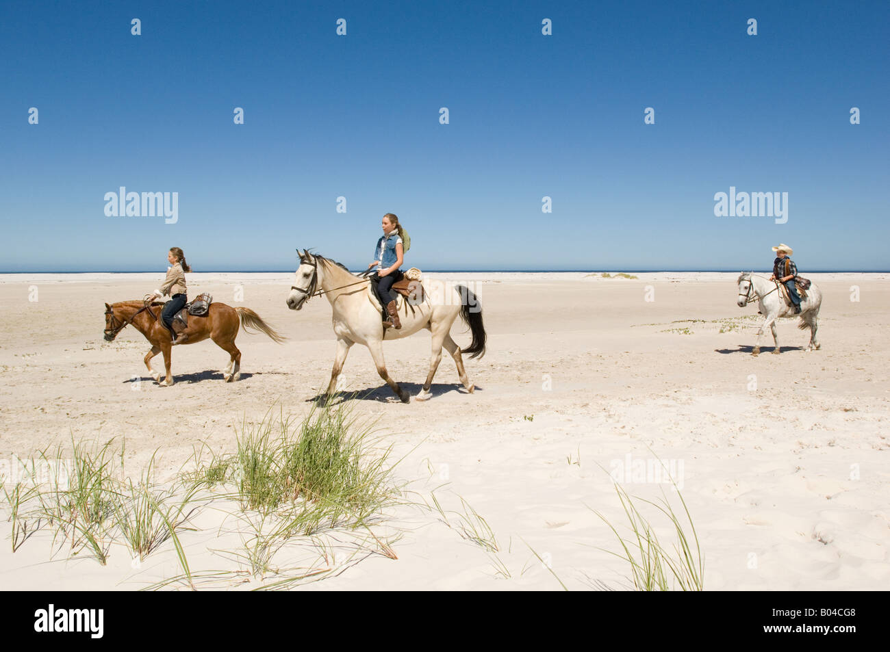 A boy and girls riding horses Stock Photo