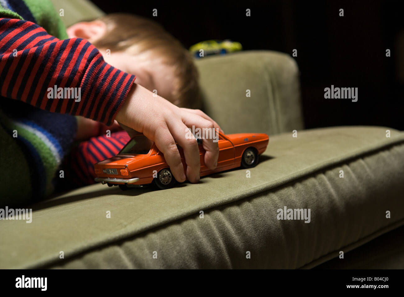 Boy playing with a toy car Stock Photo - Alamy