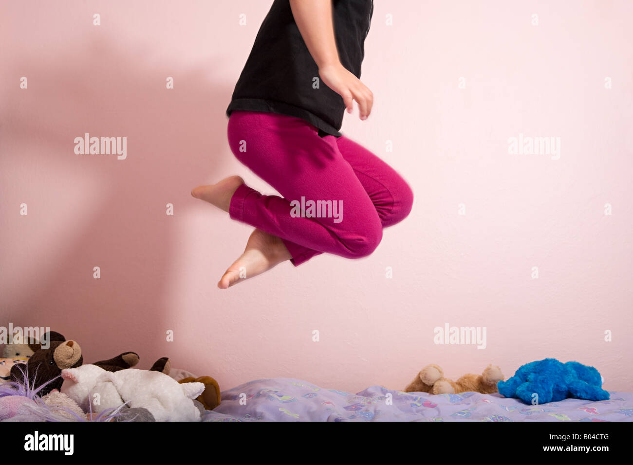 Child jumping on a bed Stock Photo Alamy
