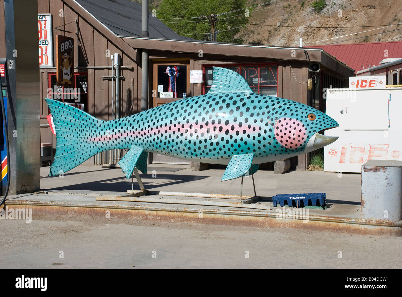 Large trout fish sculpture at Lake City Colorado gas station, USA Stock Photo