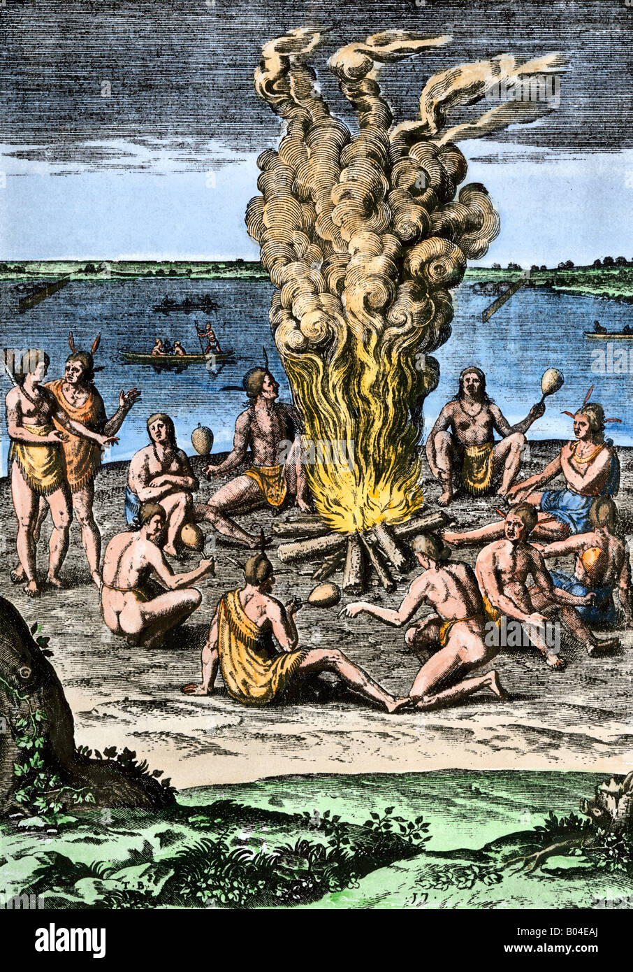 Native Americans around a fire on the Virginia North Carolina coast 1500s. Hand-colored woodcut Stock Photo