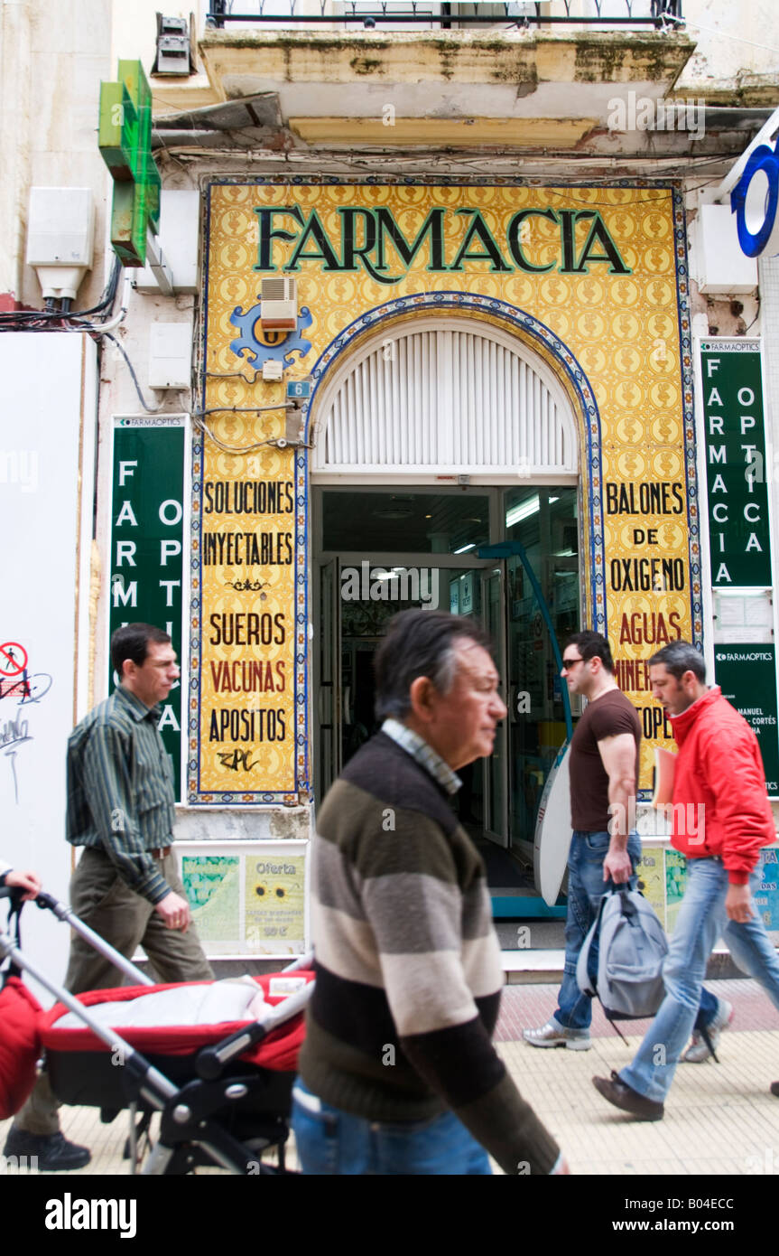 Spain Andalucia April 2008 Huelva Passers by in front of a traditional chemist shop Stock Photo