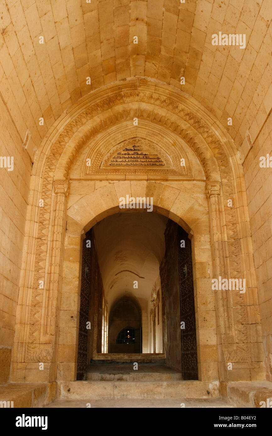 The entrance tunnel at the Deyr az Zaferan monastery with Syriac inscriptions above the doorway Mardin Turkey Stock Photo