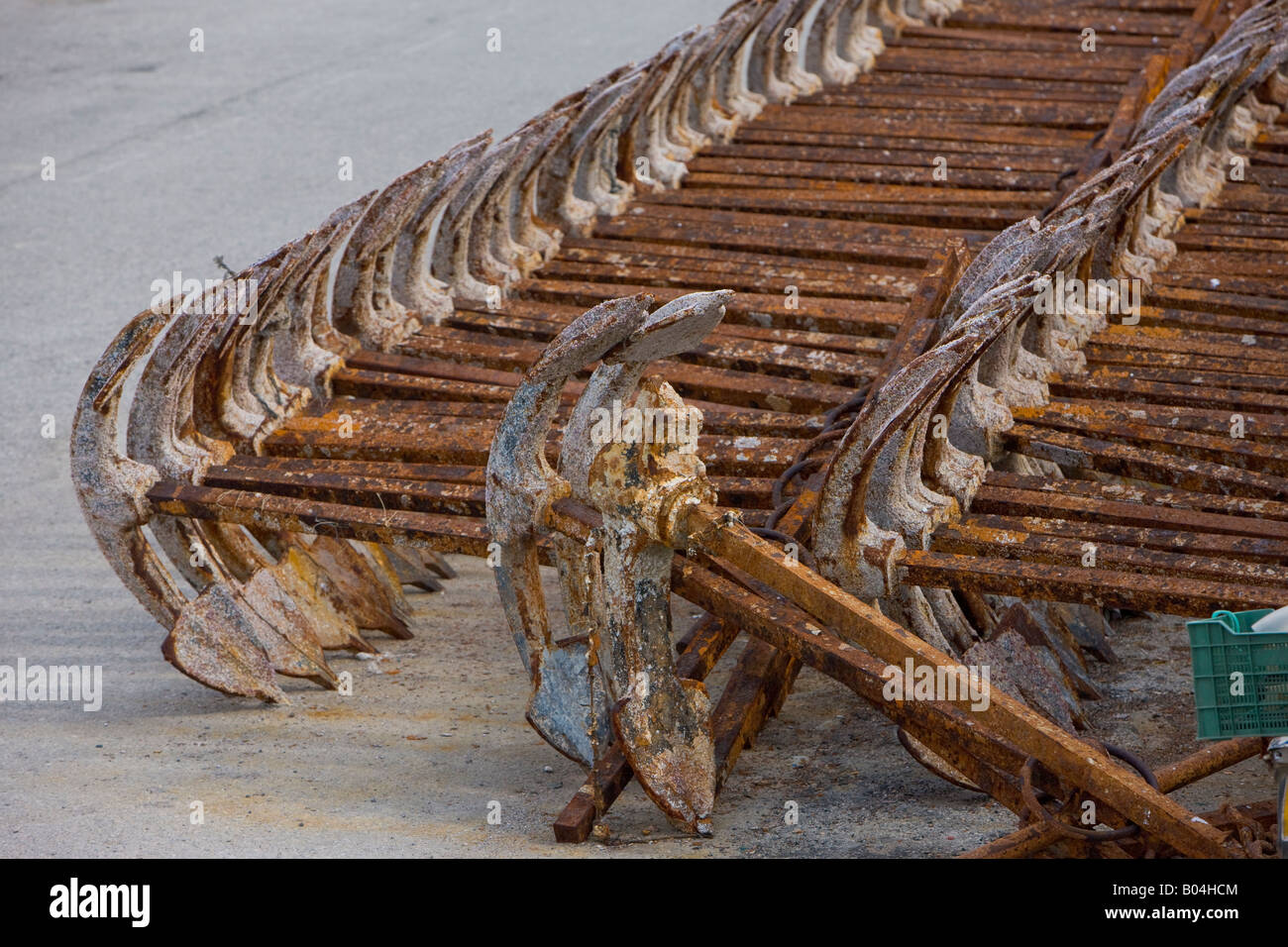 Rows of rusty anchors lying on the wharf in the town of Tarifa, Costa de la Luz, Province of Cadiz, Andalusia (Andalucia). Stock Photo