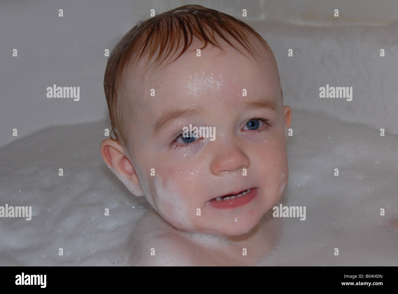A toddler enjoys a fun bubble bath Stock Photo Alamy