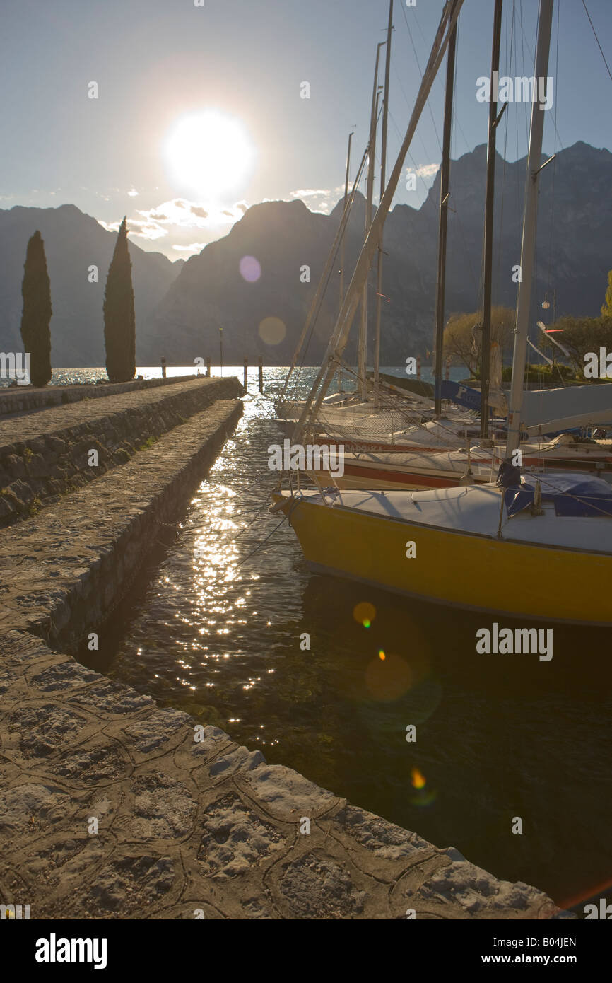 Sailboats tied up in a harbour along the Lake Garda waterfront in the town of Torbole, Province of Trento, Trentino-Alto Adige Stock Photo