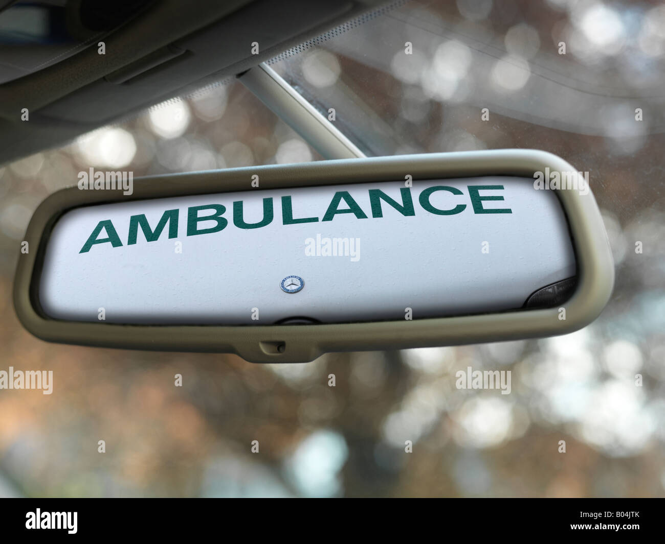 Reflection Of The Word Ambulance In Car Rear View Mirror Stock Photo