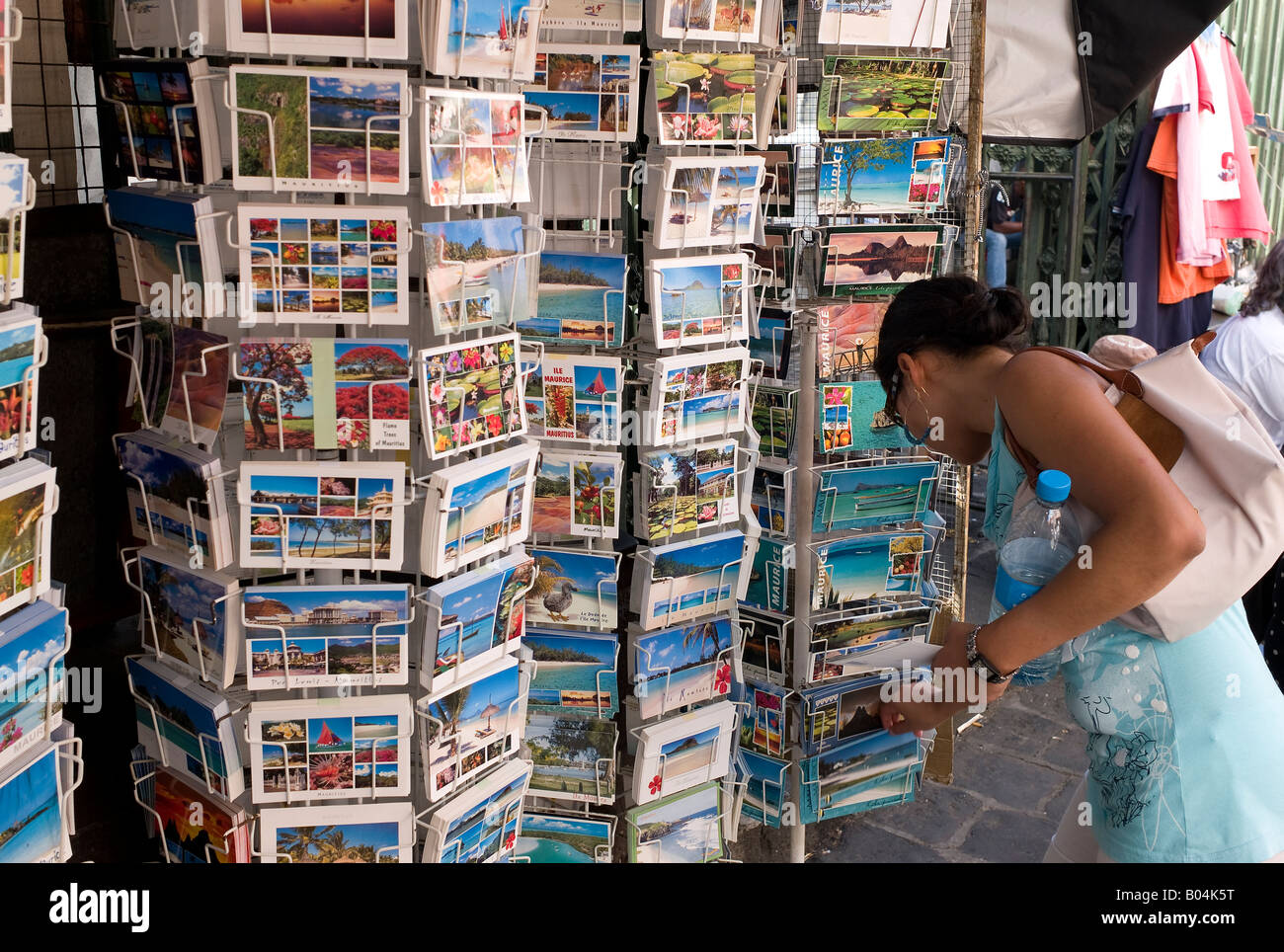 A woman buying postcards at Port Louis market, Mauritius Stock Photo